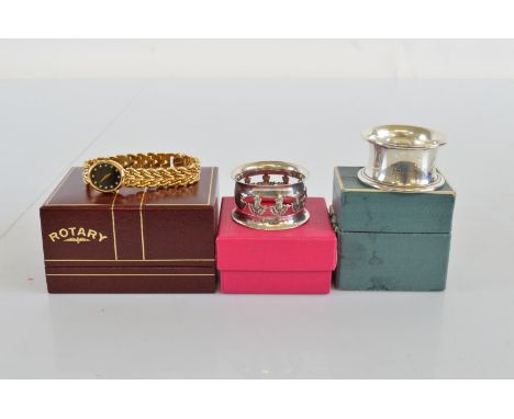 A lady's quartz Rotary wristwatch, with black face together with two silver napkin rings, one with thistle design, the other 