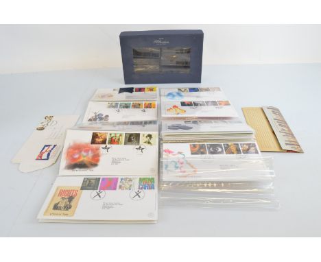 A collection of Millennium first day covers, in a blue Royal Mail presentation box with other stamps