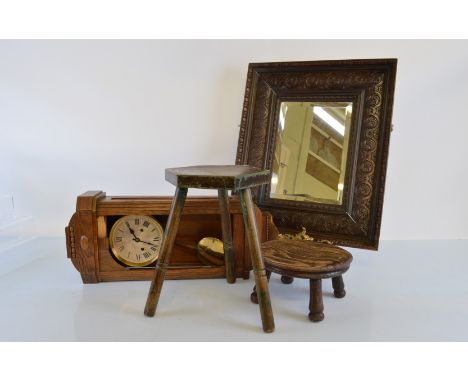 A rectangular oak carved wall mirror, having roundel design with bevelled glass, 61cm x 51cm together with an oak framed wall