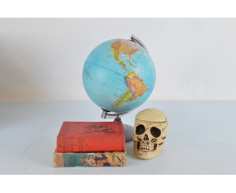 A students globe,  39 cm high, together with a skull tobacco pot and cover, two 1930s travel books 