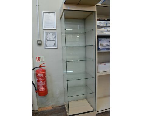 A narrow open display cabinet, having five glass shelf interior om plinth base, 49cm x 44cm x 186cm high