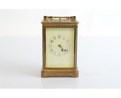 An Edwardian brass carriage clock, with repeater movement, paired case, with cream enamel dial, with white enamel Arabic nume