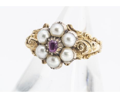 A 19th Century posy ring, centred with a cushion cut ruby surrounded by six half cut pearls, on an ornate scroll shank with p