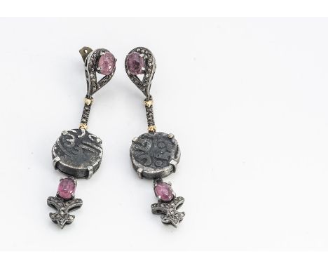 A pair of Indian coin diamond and ruby silver set ear drops, with cabochon rubies, claw set Indian silver coins with diamond 