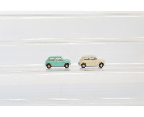 Two unboxed Tri-ang Spot-On 211 Austin Seven diecast model cars, in cream, generally G, and light turquoise,F with some 'touc