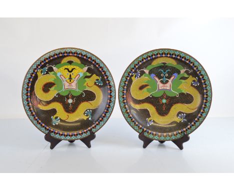 A pair of late 19th century Chinese cloisonne chargers, depicting dragon and flaming pearl,  36.5 cm diameter 