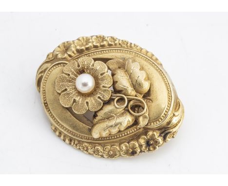 A continental yellow metal and cultured pearl oval brooch, of floral design with a leaf and flower border with pin back, unma