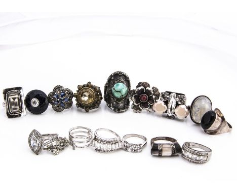 A collection of silver gem set dress rings, including examples with moon stones, mother of pearl, turquoise, citrine and many