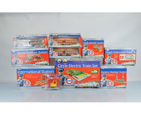 A collection of Underground Ernie model railway sets and accessories, including Circle Electric Train Set, International Stat