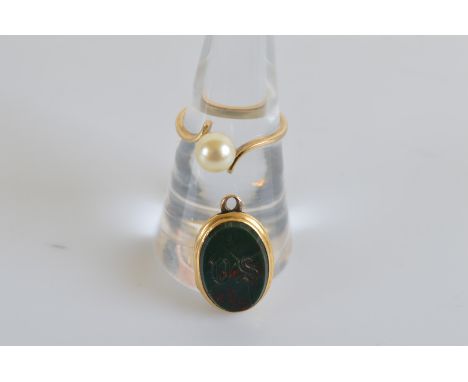 An oval bloodstone locket, with working hinge, engraved with initial DS, 2cm x 1.3cm together with a 9ct gold pearl dress rin