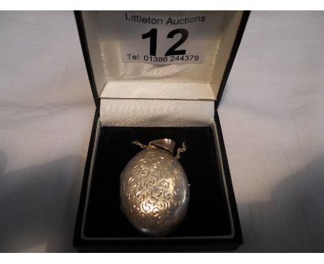 Silver locket and chain - Estimate £15 to £30 