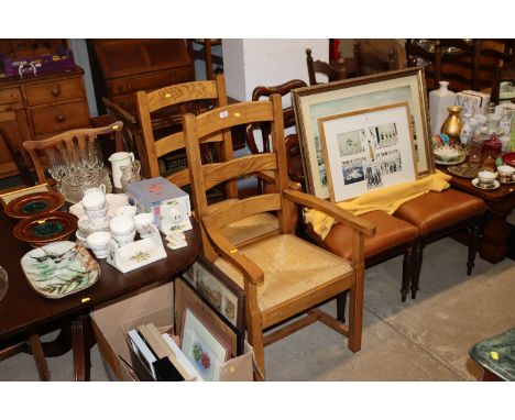 A pair of light oak ladder back and rush seated elbow chairs 