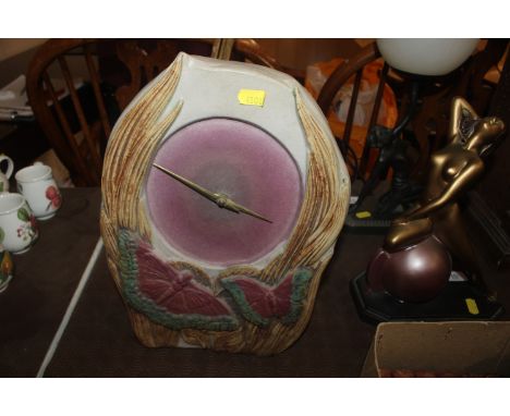 A Bernard Rooke pottery mantel clock decorated with butterflies, initialled B.R. 32cm high 