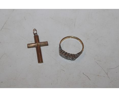 An 18ct gold and platinum illusion set three stone diamond ring, ring size N.O, approx. 2.8gms; and a 9ct gold crucifix penda