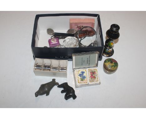 A box containing napkin rings, magnifying glasses, paperweight etc.