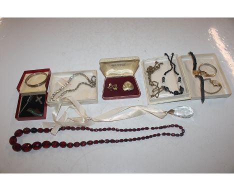 A box containing a silver snap bangle, a silver brooch in the form of an arrow; a white metal brooch in the form of a leaf; a