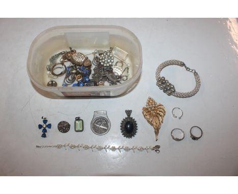 A box of costume jewellery to include brooches, dress ring etc.