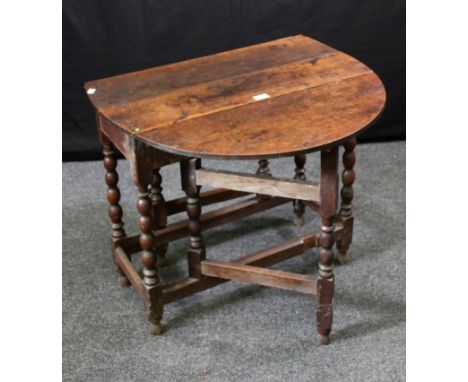 A late 17th century oak bobbin turned oval gate-leg table, 74cm wide