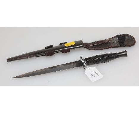 A 3rd pattern Fairburn Sykes fighting knife and scabbard, the grip bearing a raised emblem for Popskis Private Army, 34cm lon