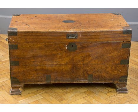 A 19th century brass banded teakwood campaign box, with sunken handles and name plate, raised on later bracket feet, 105cm wi