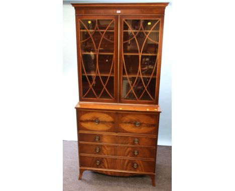 A Bevan Funnell mahogany and satinwood crossbanded secretaire bookcase, the moulded cornice over a pair of shaped barred glaz