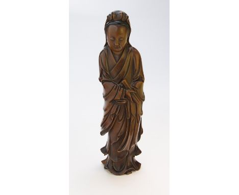 A 19th century Chinese carved boxwood figure of Guanyin holding a scroll, 25 cm