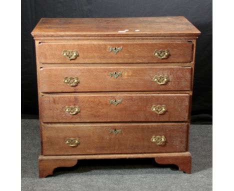 A George III oak chest, the rectangular top with moulded edge, over four graduated long drawers, with brass batswing drop han