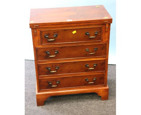 A reproduction burr and figured yew veneered bachelor's chest, the fold-over rectangular top over four long drawers with bras