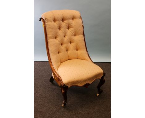 A Victorian rosewood framed parlour nursing chair, having a rolled button upholstered back, serpentine fronted overstuffed se