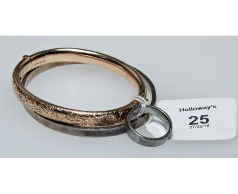 An Edwardian 9ct gold bangle, engraved to centre with push button thumbpiece, together with a silver bangle and ring en suite