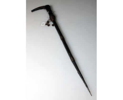 A 19th century Songye ceremonial knife, with blackened figural bone handle and 39cm steel blade in a wire  bound wood scabbar