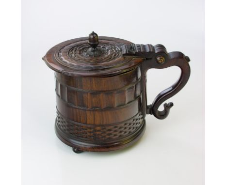 A 17th century English lignum vitae 'York' tankard, the hinged cover with acorn finial, the cylindrical body worked with band