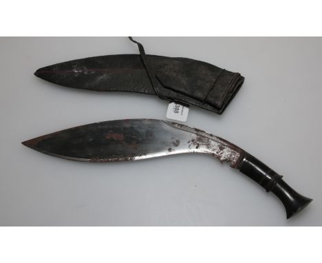 A 19th century Nepalese Kukri, curved single edged blade, with forte notches, horn grip, the scabbard mounted with white meta