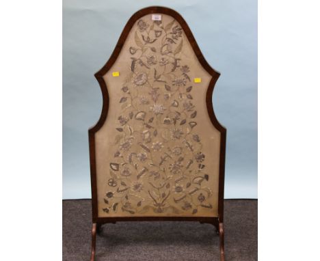 An Edwardian walnut framed firescreen, with inset 19th century bullion thread and bead worked panel depicting flowering shrub