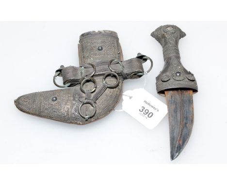 A late 19th century, possibly childs, Jambiya, the 8.5cm double ridged blade with wire work overlaid silver grip, in a leathe