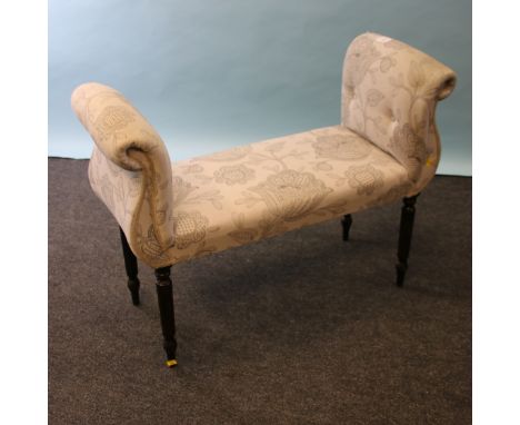 A late Regency/William IV style window seat, button upholstered with scrolled ends and overstuffed seat on turned tapering re