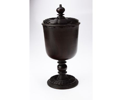A 17th century lignum vitae goblet and cover, with knop finial and channelled wavy bands, over a plain body, knopped ring tur