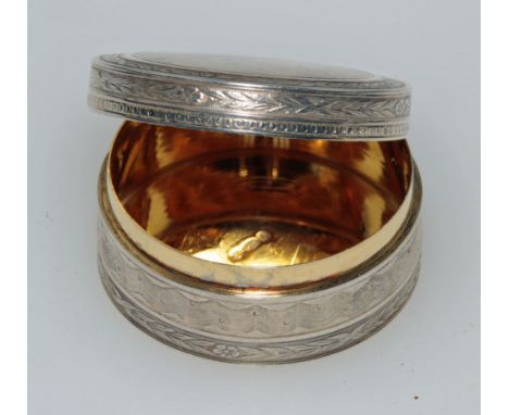 Louis Dessouter, an early 20th century silver box of cylindrical form, with all over engine turned decoration and gilded inte