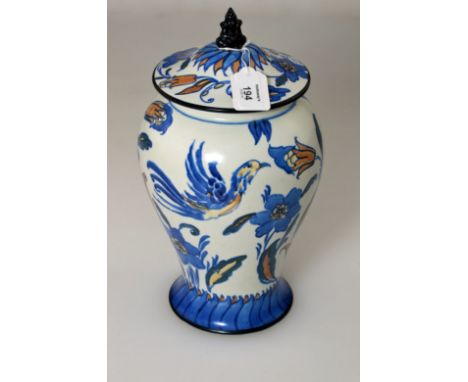 Frederick Rhead for Wardle, an earthenware covered jar, with seated figural finial, decorated in orange and blue with Phoenix