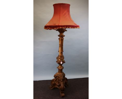 A 17th century style Venetian carved wood and gilt gesso altar candle stand (now a lamp), with scroll wreath and figural deta