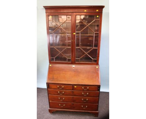A George III mahogany astragal glazed bureau bookcase, the base with stepped pigeon hole interior with two short over three l