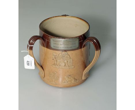 A large Doulton Lambeth stoneware tyg, decorated in relief with tavern and hunting scenes, bearing plaque 'Broadway Lawn Tenn
