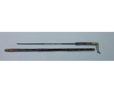 A 19th century sword stick, the 44cm square section blade with cane hilt and a gilded white metal handle fashioned as a lady'