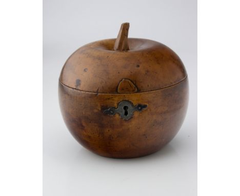 A George III fruitwood tea caddy, of apple form, with carved stalk, brass hinge and winged iron escutcheon, 12.5cm