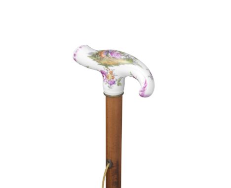 A Berlin porcelain cane handle, mid 18th centuryof rocaille shape, the terminal moudled as a shell, decorated with a pastoral
