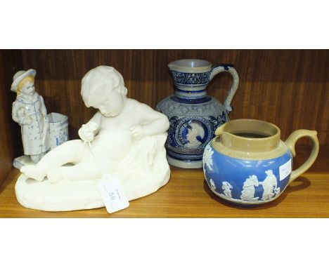 A parian figure of a cherub lying down, holding a flower, 22cm long, 17cm high, an Oriental ceramic floral-decorated bowl, 25
