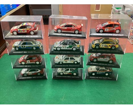 Twelve 1:43rd Scale Diecast Model 'Partworks' Rally Cars to include Skoda Fabia WRC, Citroen BX 4TC, cased.