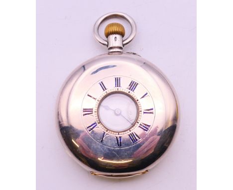 A 925 silver half hunter pocket watch. 5 cm diameter.