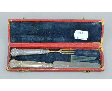 A cased silver knife and fork. The case 17.5 cm long.
