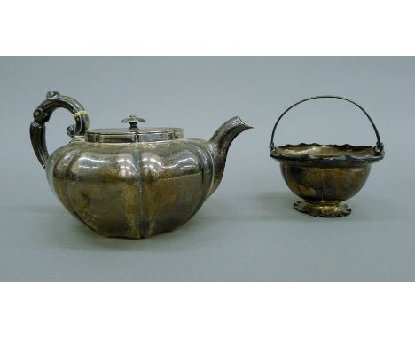 A silver teapot and a sugar bowl. The teapot 23 cm long.  914.1 grammes total weight.Note: This lot is sold with an ivory exe